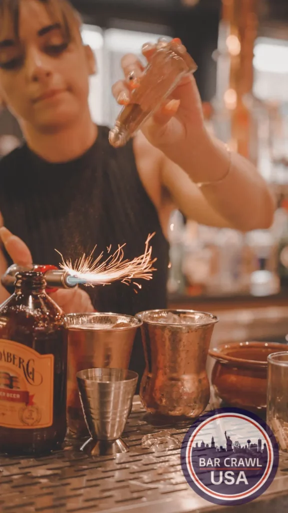 close up image of a bartender lighting a shot on fire