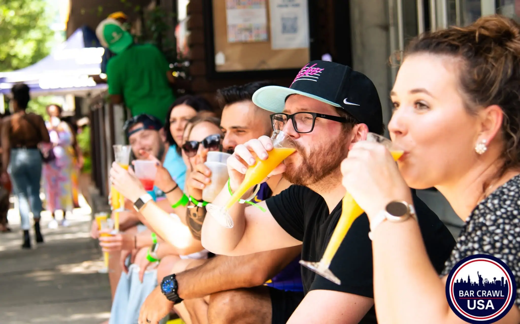 Boozy brunch crawlers enjoying mimosas by Bar Crawl USA